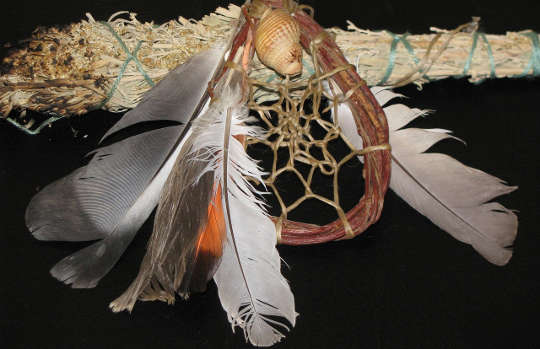 sage smudge sticks, feathers, and a dreamcatcher